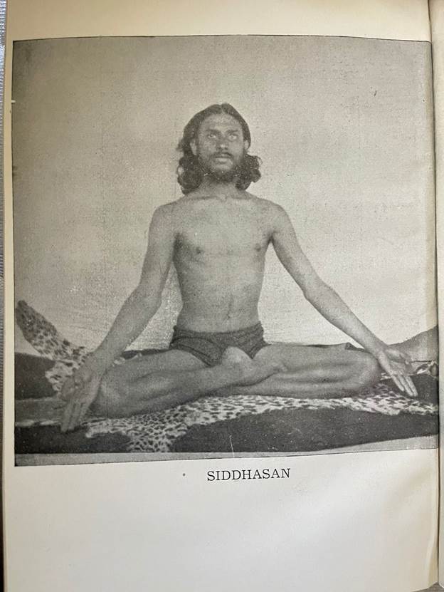 A person sitting in a yoga pose

Description automatically generated